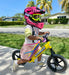 Strider 2-in-1 Full Face Kids Bike Helmet - Child wearing pink helmet