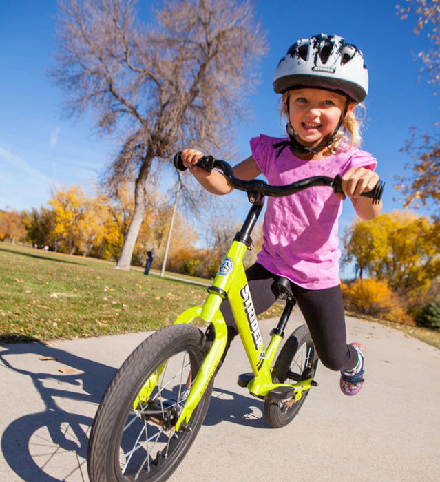 Strider Splash Kids Bike Helmet - White with Black Splash on child riding outside